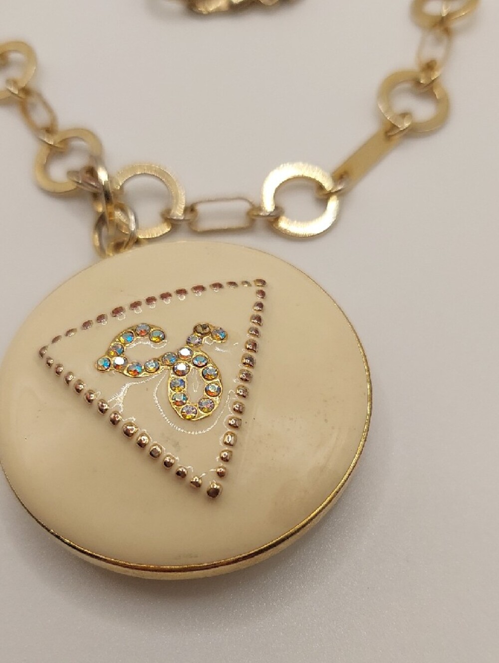 GUESS Blingy AB Gold-Tone Long Pendant Necklace with Cream Enamel Locket - Picture 9 of 14